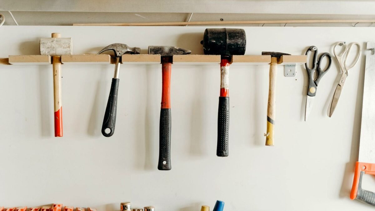 Tools neatly hanging on a workshop wall in a hardware store.