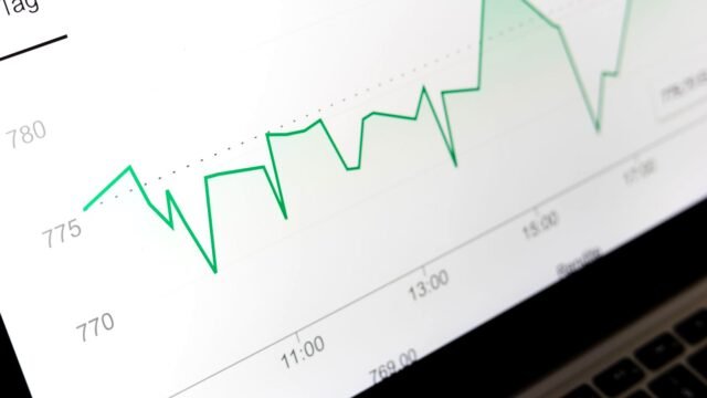 Laptop with a website open and a chart of traffic figures next to it