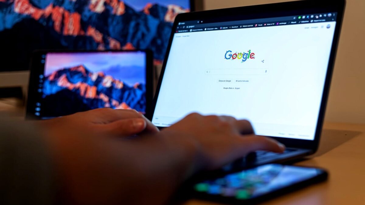 Hands typing a query on a laptop showing a search engine page