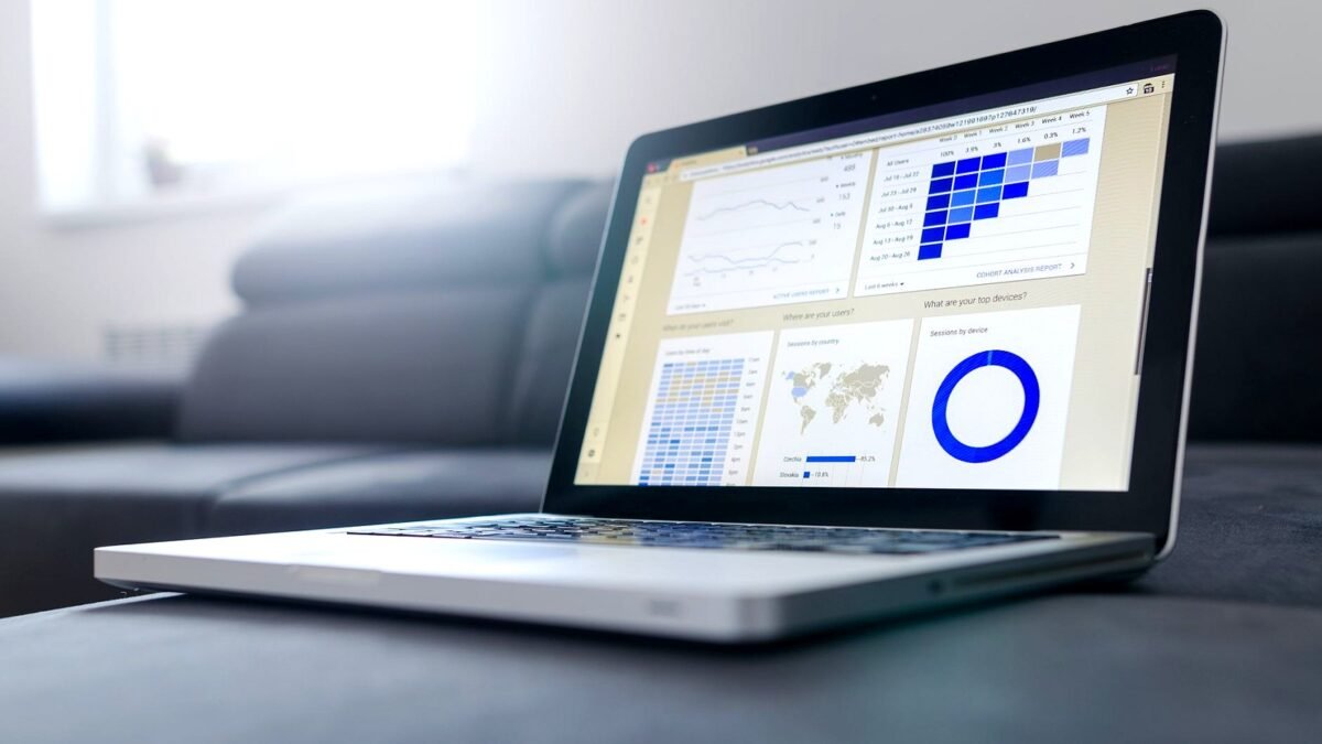 Sleek laptop showcasing data analytics and graphs on the screen in a bright room.