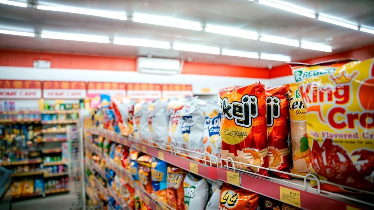 Shelves in a supermarket aisle packed with colourful boxes and packets of food