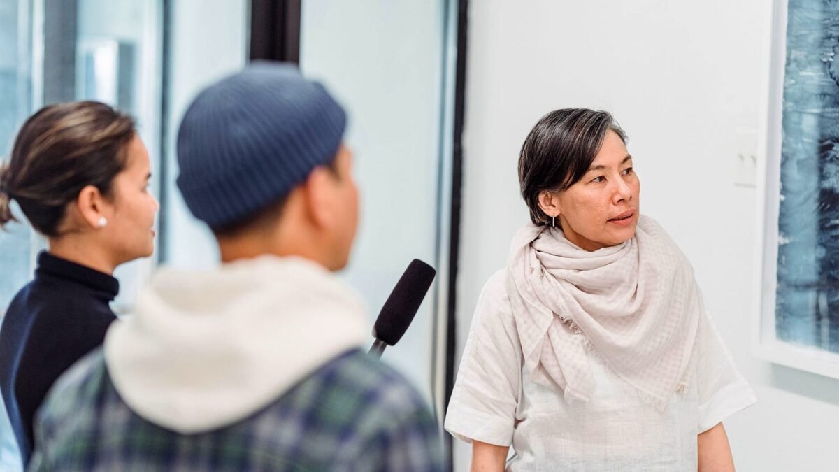 Reporters recording an interview with a person indoors