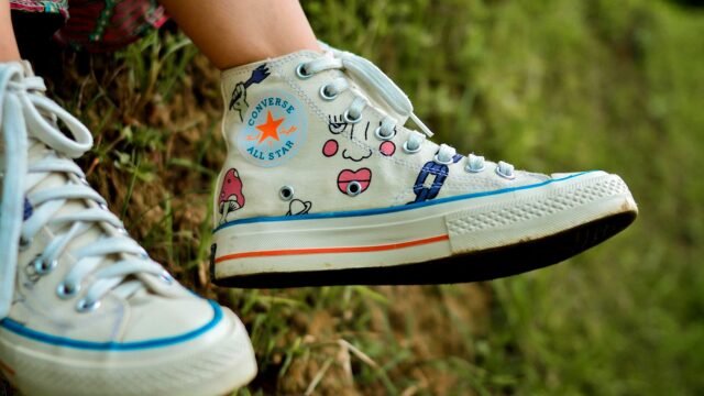 Close-up of colourful Converse canvas sneakers worn outdoors