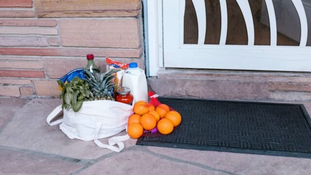 Reusable bag of groceries left on a doorstep
