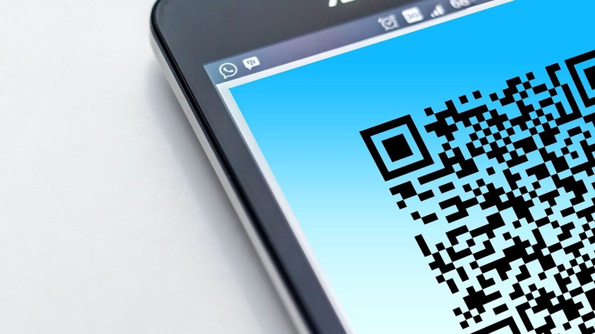 High-resolution close-up of a smartphone displaying a QR code on its screen.