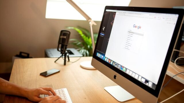 Desktop computer screen showing a Google search results page on a desk