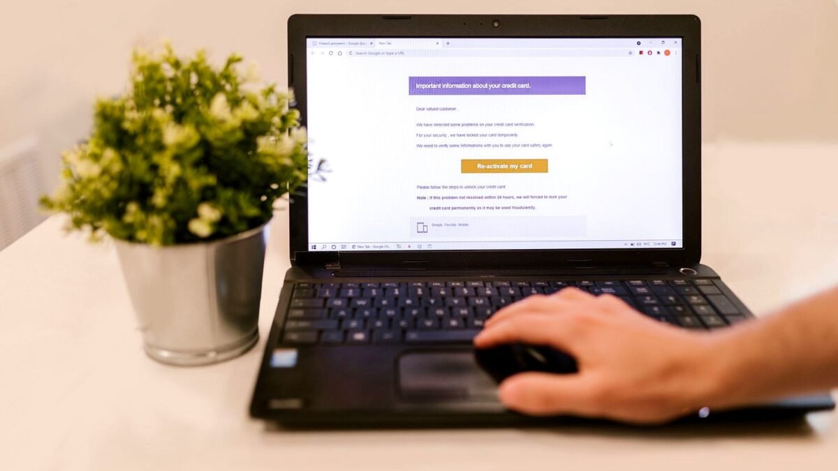Person reading an email on a laptop at a desk