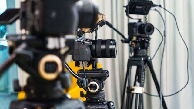 Professional video cameras on tripods in a studio