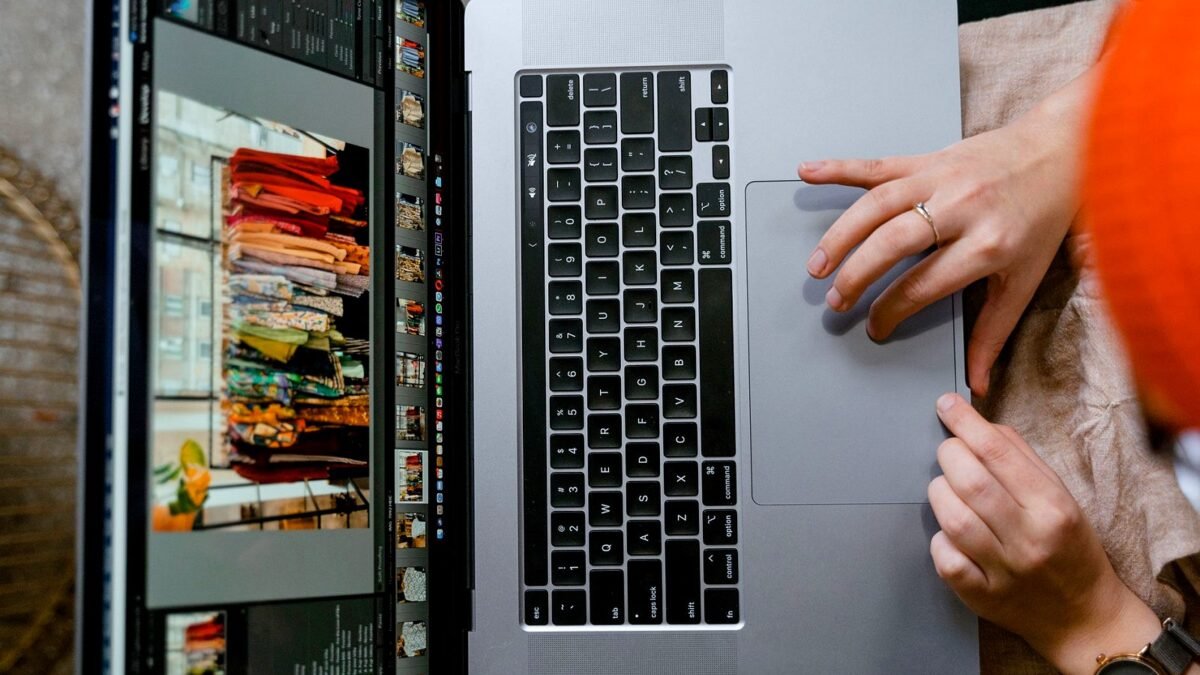 Hands on a laptop keyboard with an online clothing shop on the screen