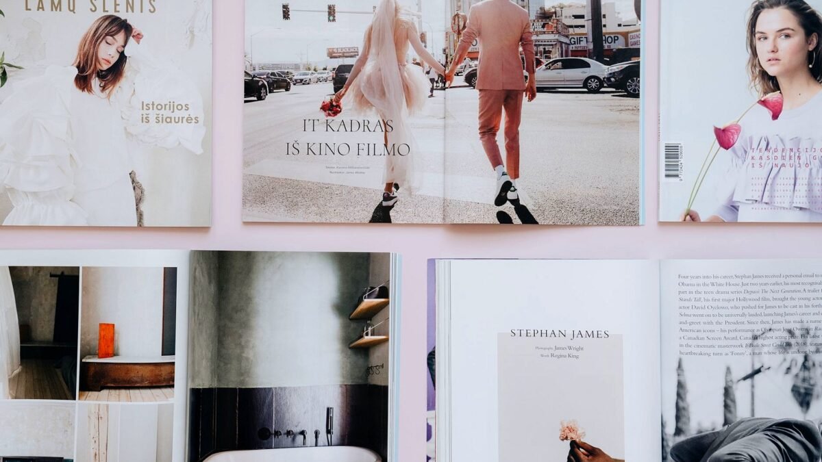 Open fashion magazines laid out side by side on a light surface