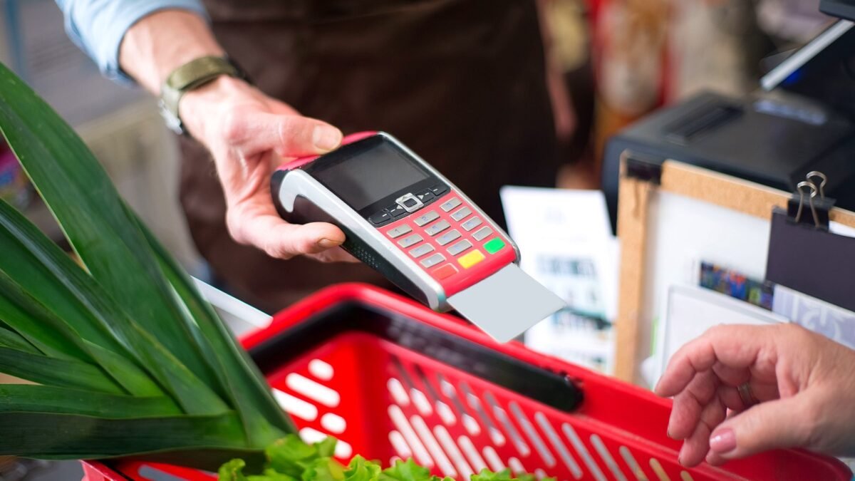 Close-up of a contactless payment at a grocery shop till