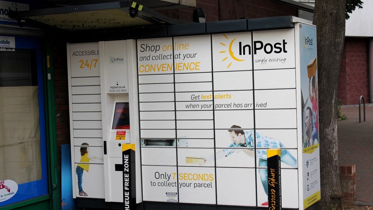 InPost parcel locker on a London street with a touch screen and yellow sun logo