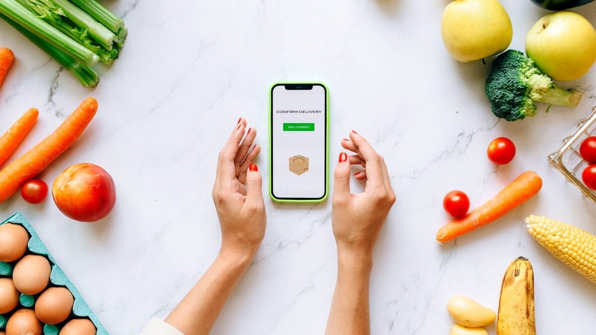 Hands holding a phone with an online grocery order on the screen