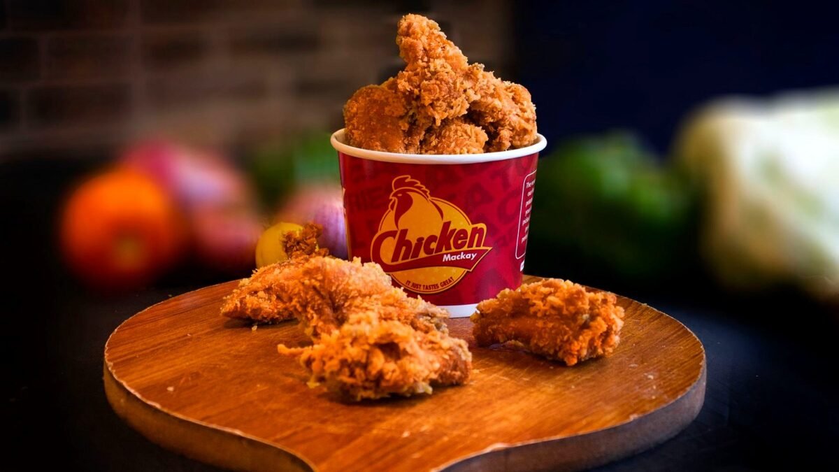 Bucket of fried chicken on a table in a restaurant, illustrating the KFC menu overhaul