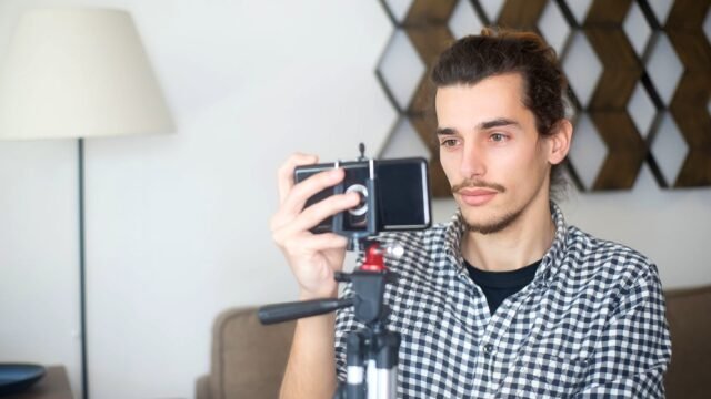 A creator films a short video on a phone set on a tripod