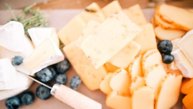 Close-up of soft cheese slices arranged on a light surface