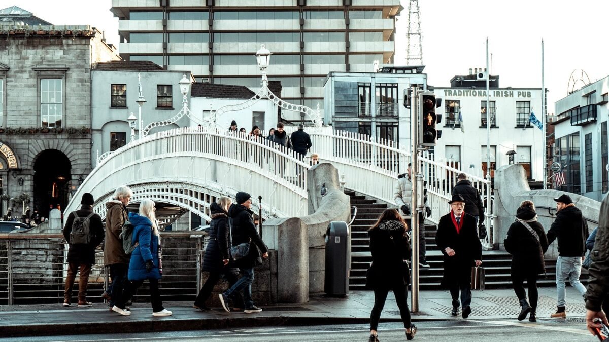 People crossing the Ha'penny Bridge over the Liffey in Dublin