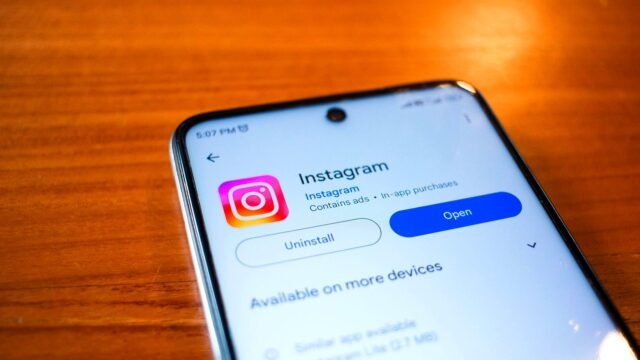 Smartphone held in one hand with the Instagram app open on screen