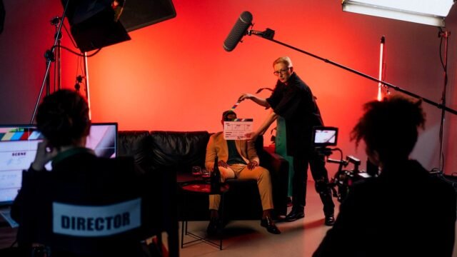 A film crew sets up a camera and lights for a short commercial shoot