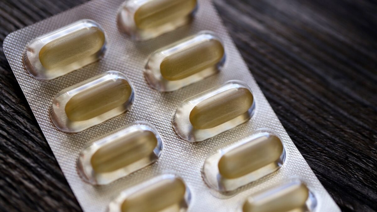 Blister pack with transparent capsules photographed close up on a textured surface
