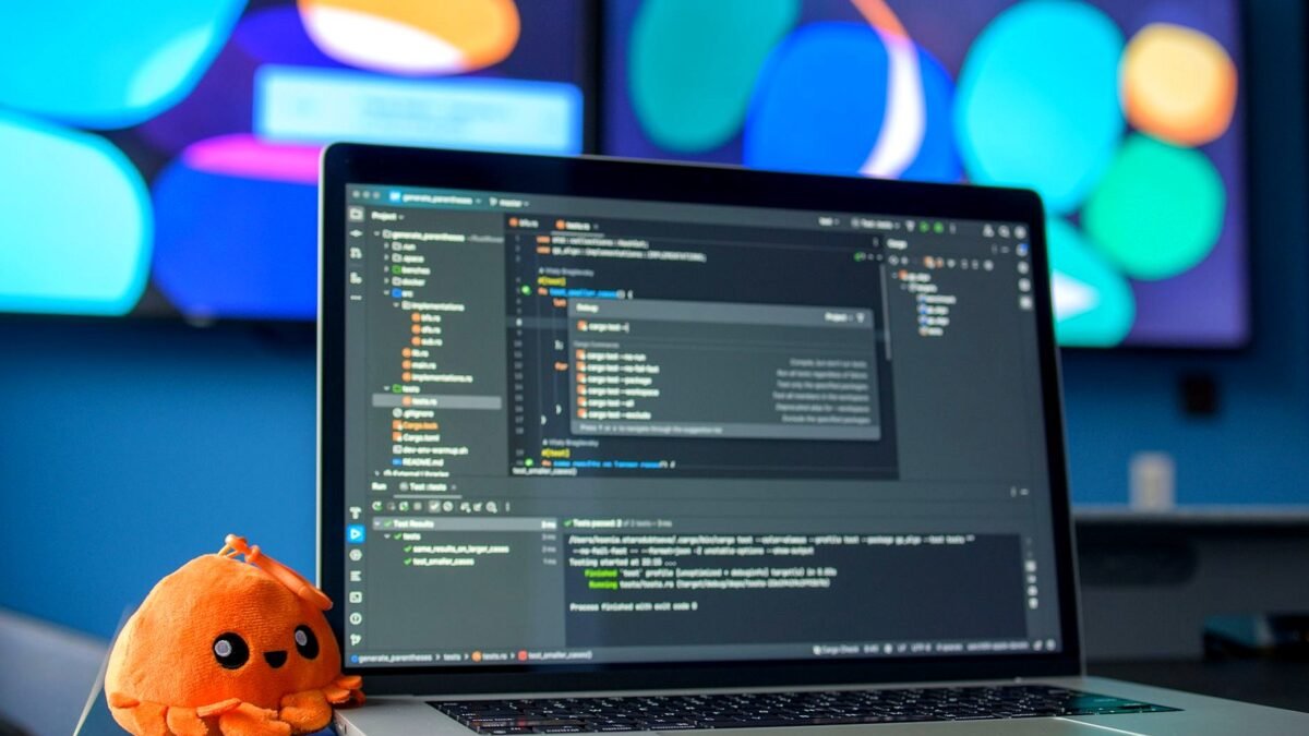 Laptop screen showing lines of program code on a desk