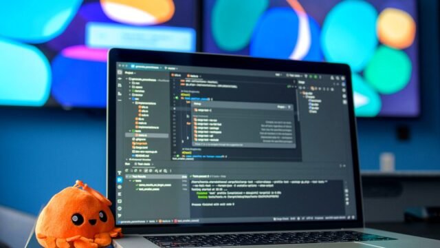 Laptop screen showing lines of program code on a desk