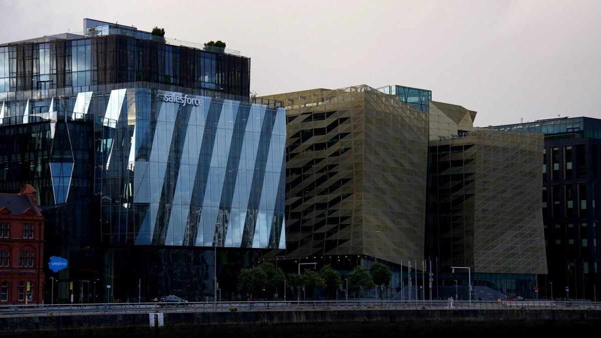 Modern glass office buildings along the water in the Dublin docklands on a clear day