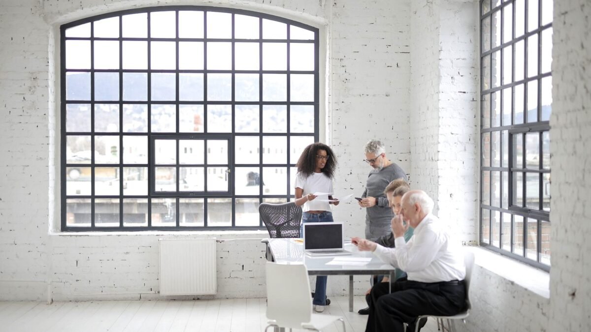 Colleagues at desks in a bright office working side by side