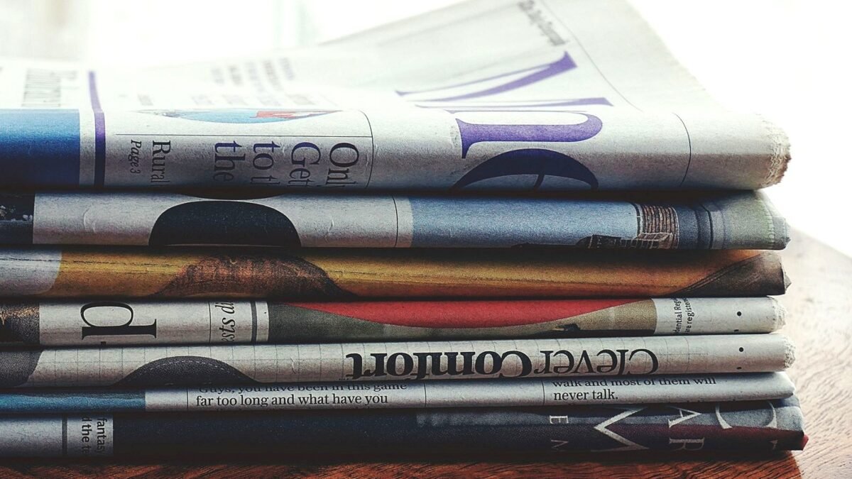 A stack of printed newspapers piled one on another