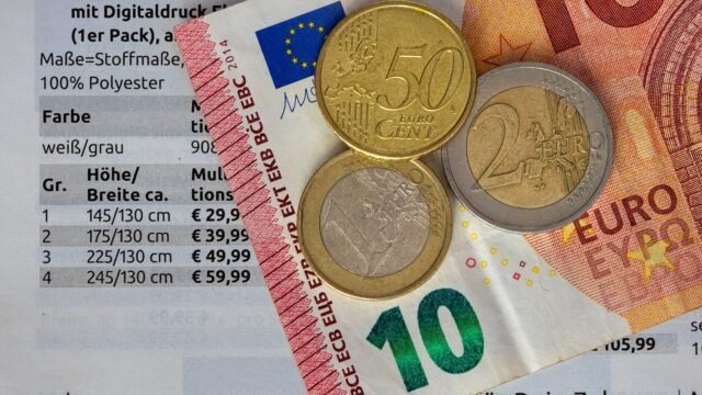Euro banknotes and coins lying on a table