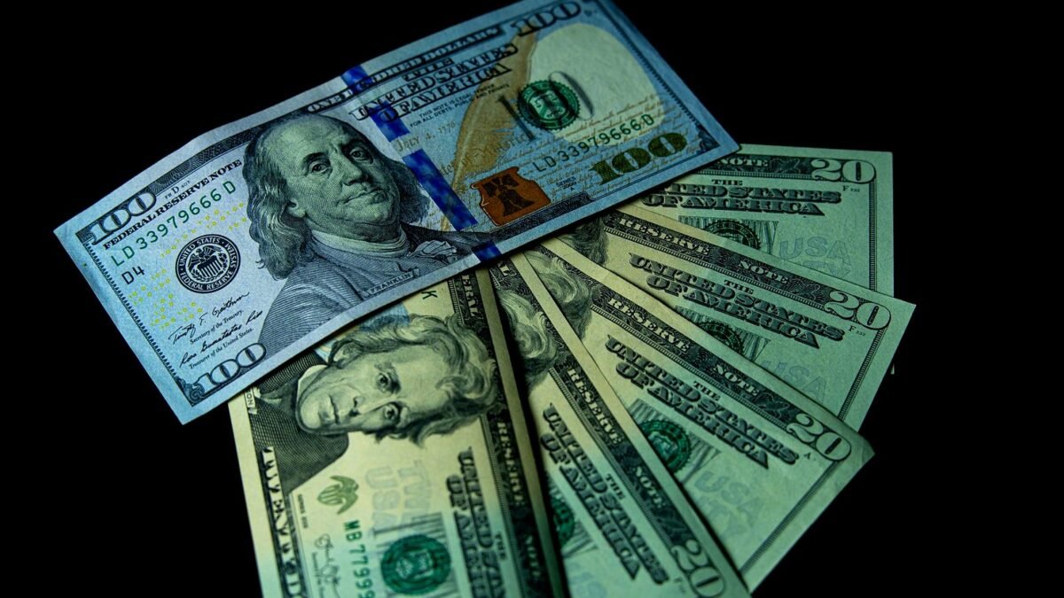 Dollar banknotes spread out on a table top