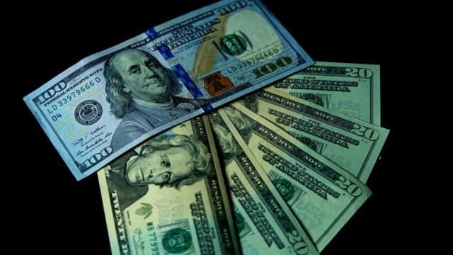 Dollar banknotes spread out on a table top