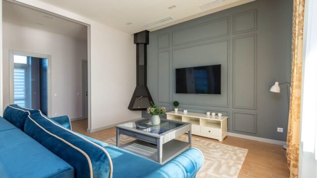 A television in a living room with a remote control nearby