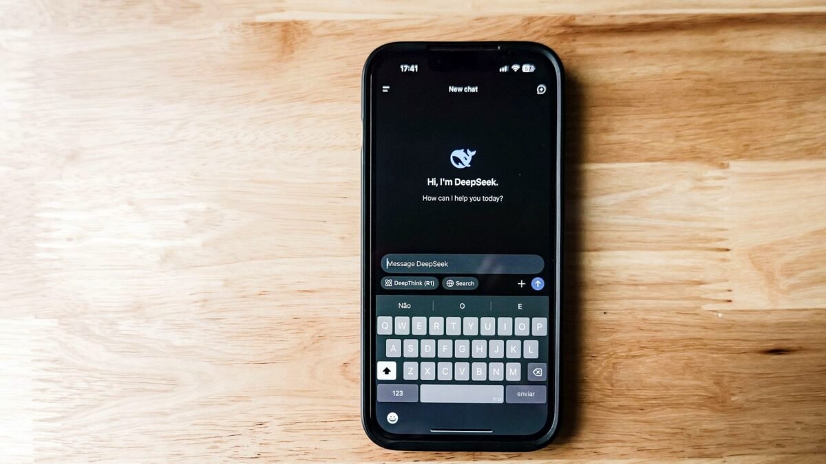 A smartphone on a wooden table showing an AI chatbot interface called DeepSeek.