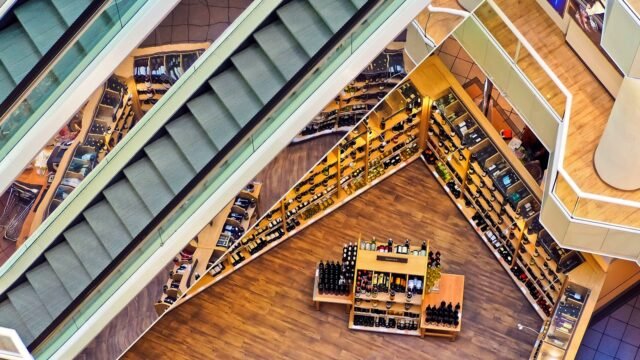 Aerial view of a stylish shopping mall showcasing escalators and well-organized retail displays.