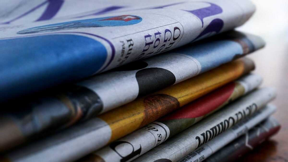 Close-up of a stack of folded newspapers on a table