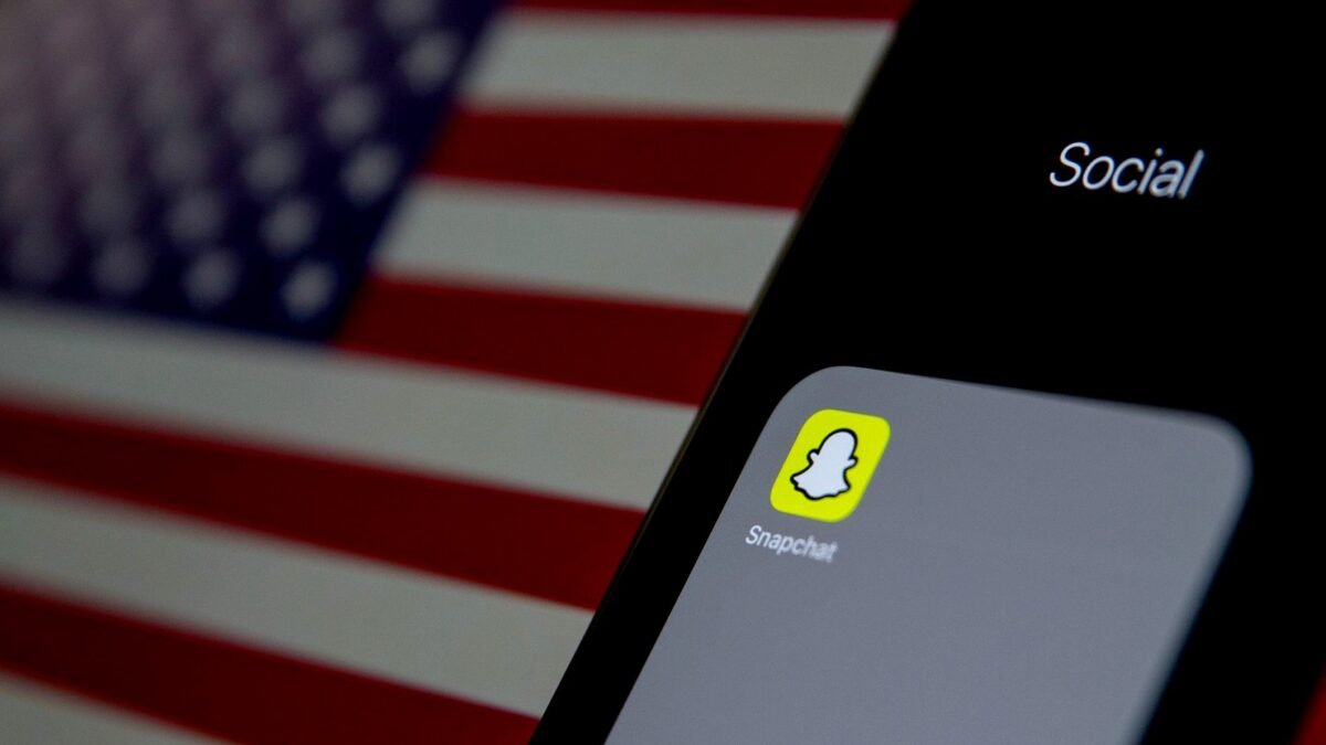 Close-up of a phone screen showing the Snapchat app icon among other apps.