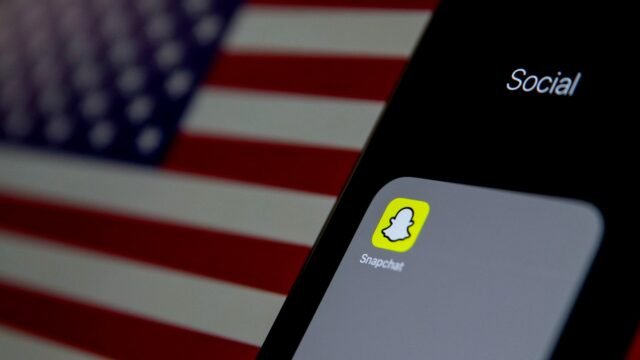 Close-up of a phone screen showing the Snapchat app icon among other apps.
