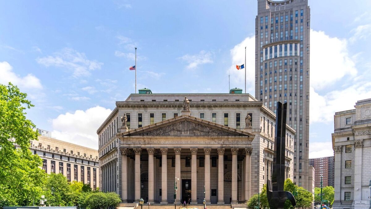 The New York County Courthouse with its columns and steps on a clear day