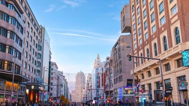 Busy Gran Via street in Madrid with advertising panels along the buildings