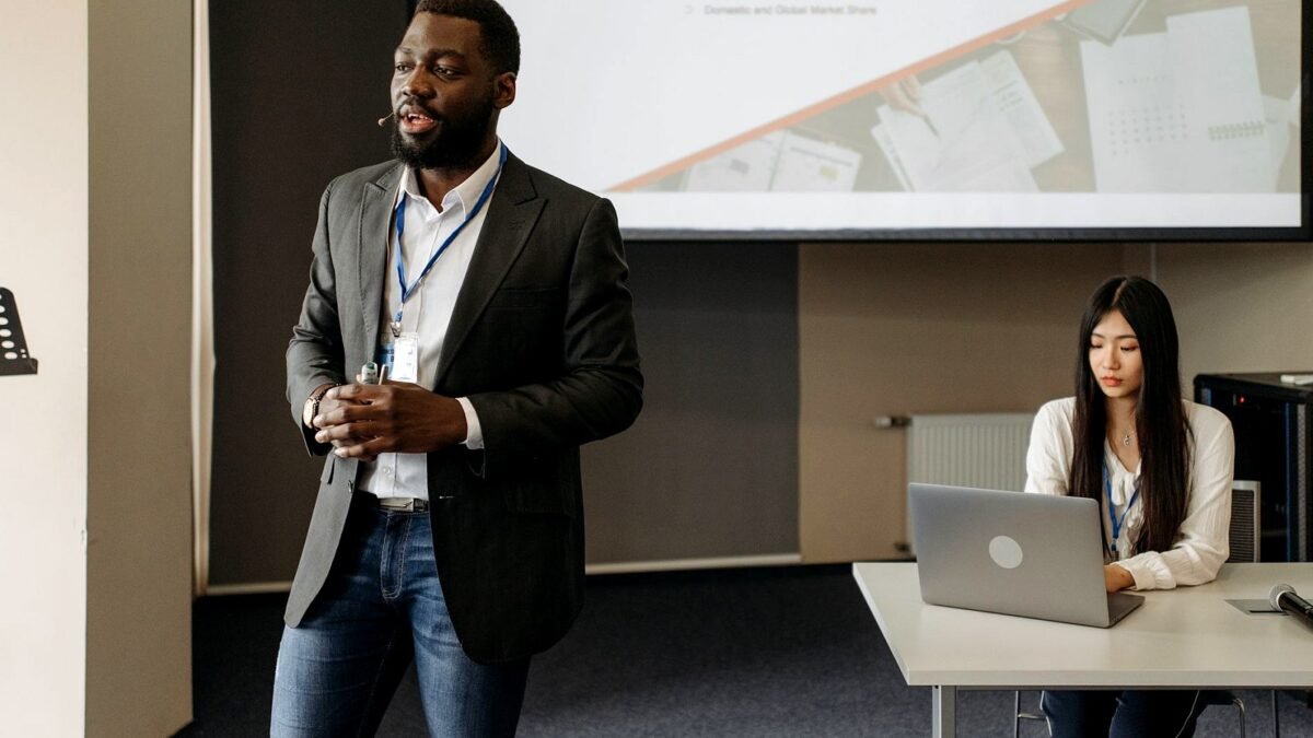 A team presenting slides to clients across a meeting room table