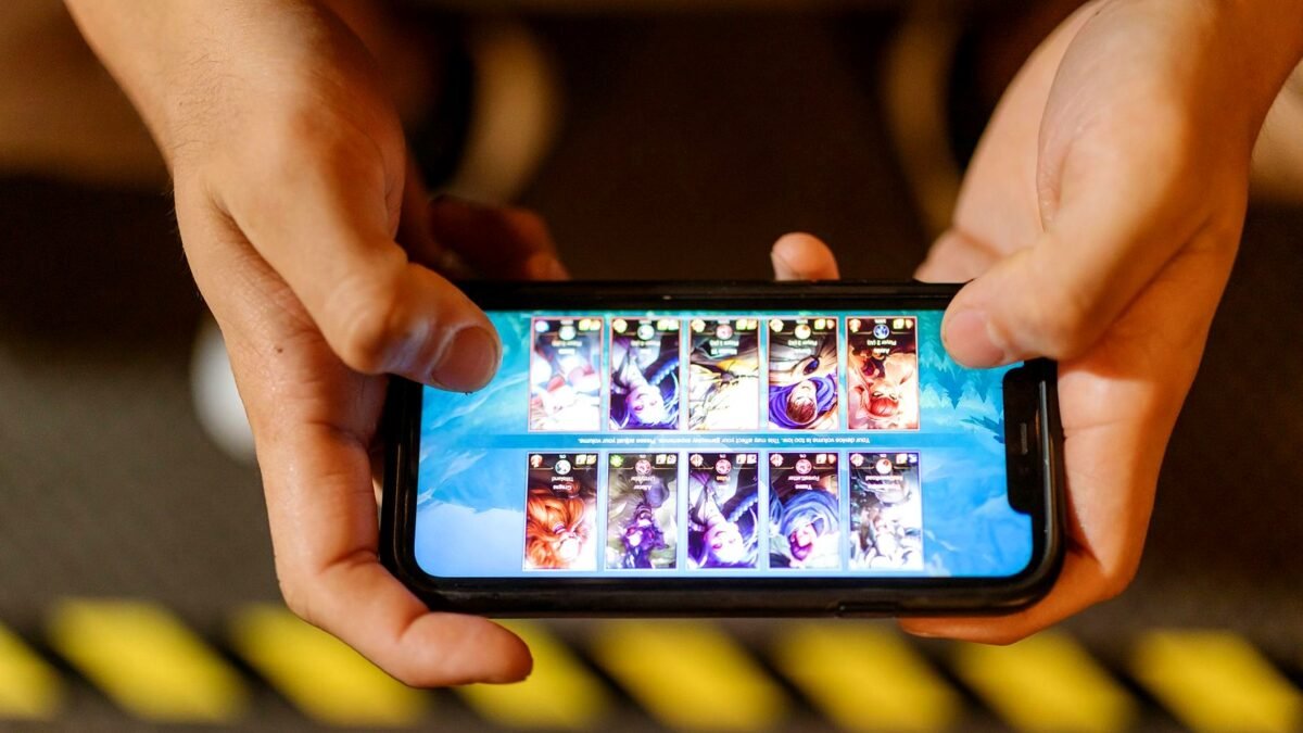 Close-up of hands playing a game on a smartphone