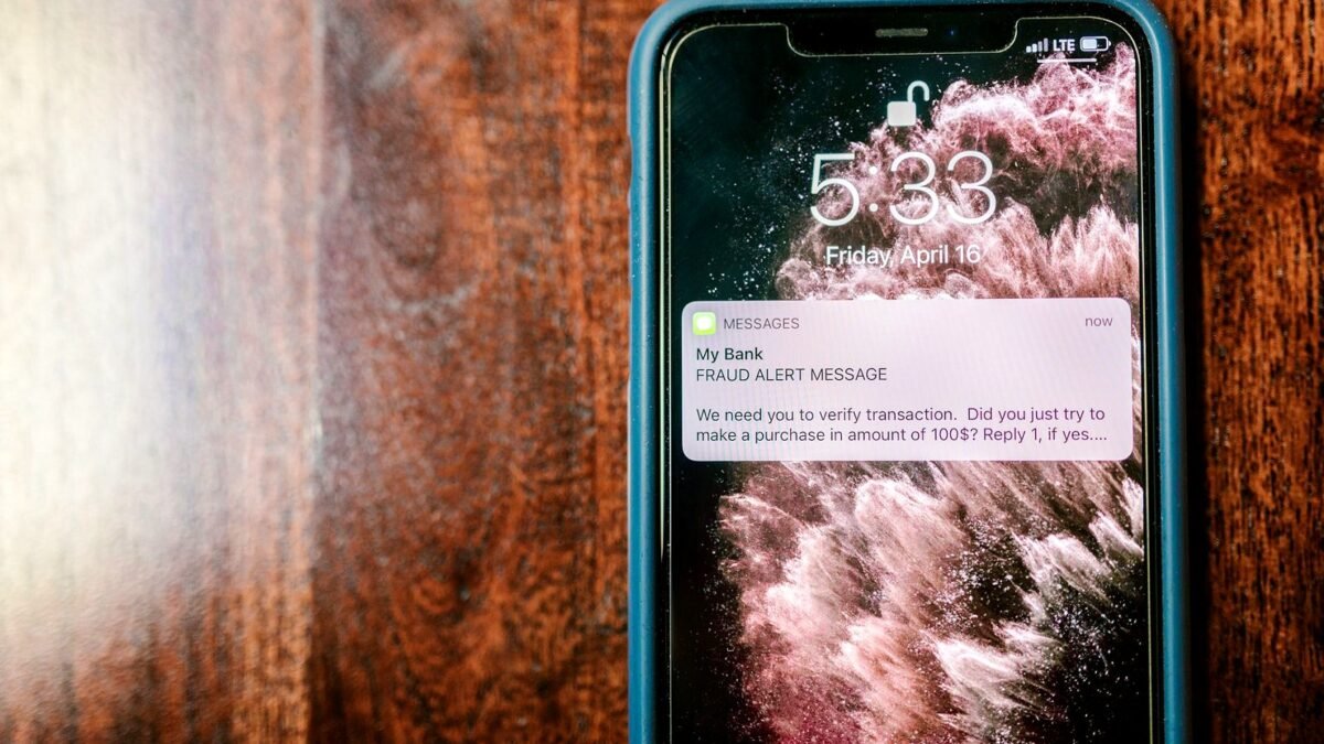 Smartphone screen showing an alert notification, held in one hand