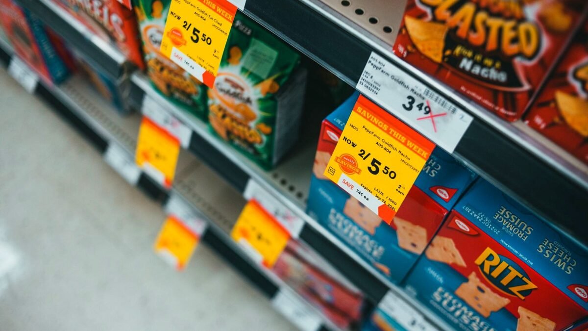 Supermarket shelf with snacks and yellow sale price tags