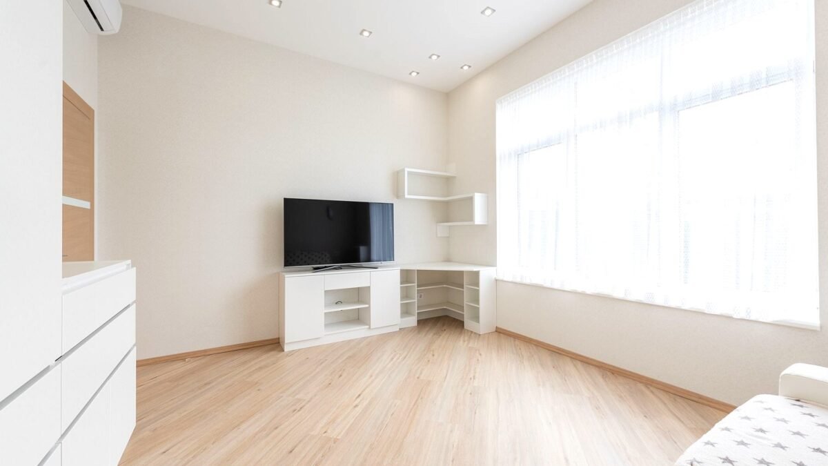 Modern television on a low cabinet in a bright, tidy living room
