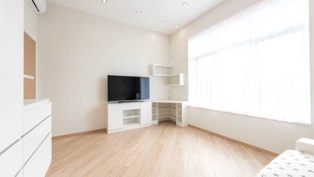 Modern television on a low cabinet in a bright, tidy living room