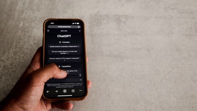 Close-up of a hand using the ChatGPT app on a smartphone