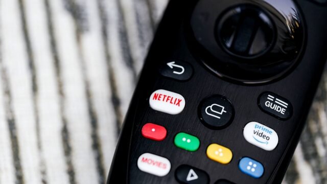 Close-up of a TV remote with buttons for streaming services