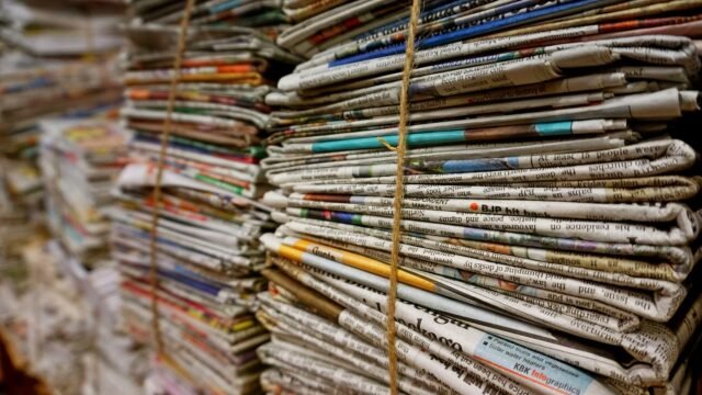 Bundles of newspapers tied with twine