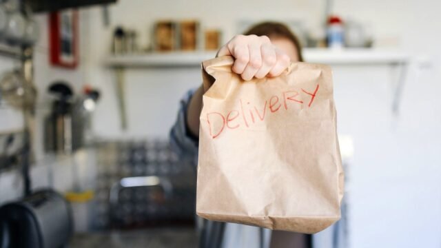 Paper delivery bag held up in a home kitchen